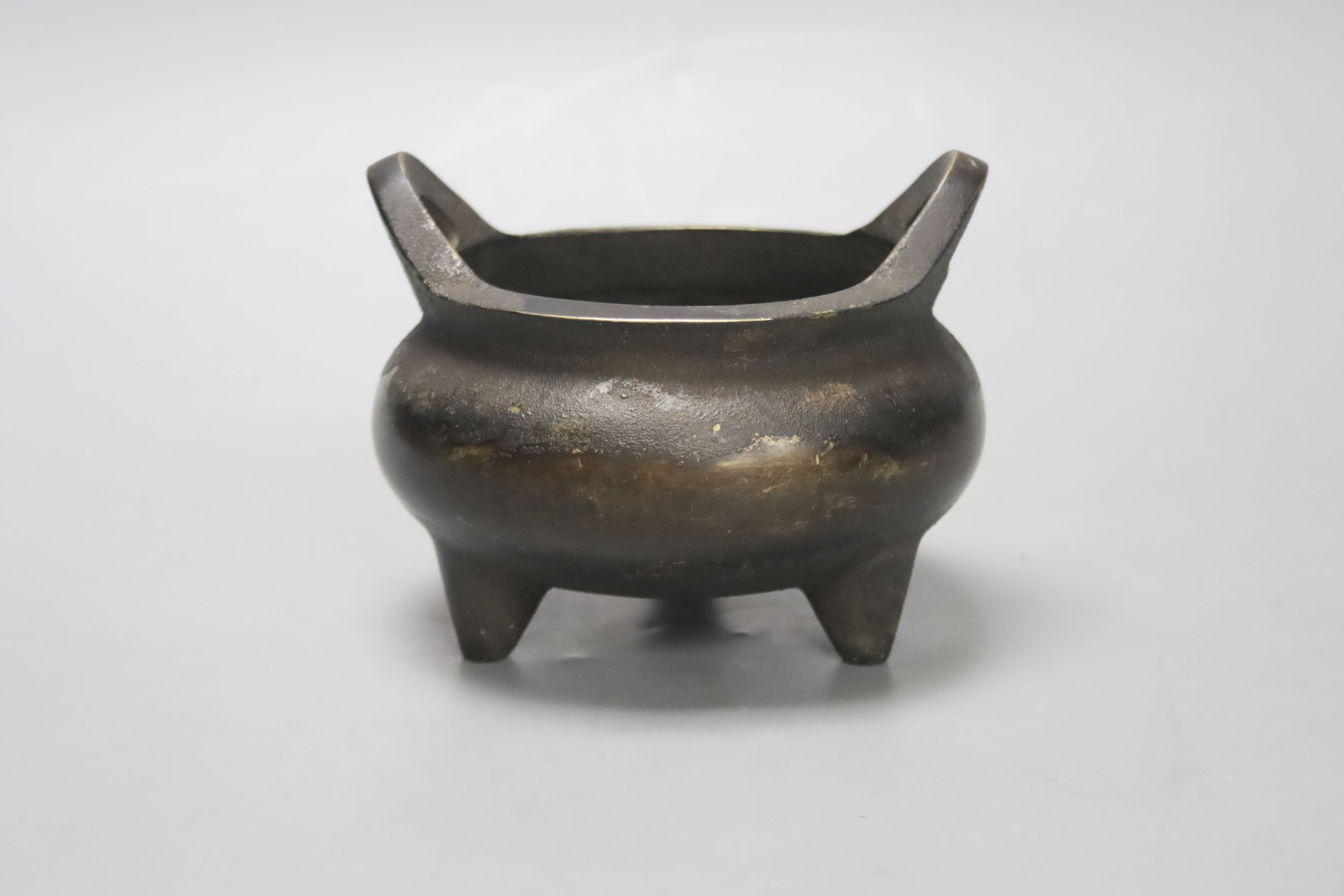 A Chinese bronze tripod censer, Xuande four character mark height 10cm